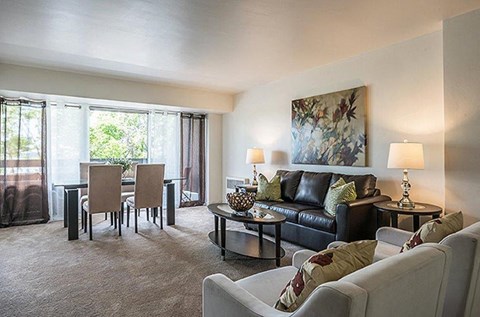 a living room and dining room with a couch and a table